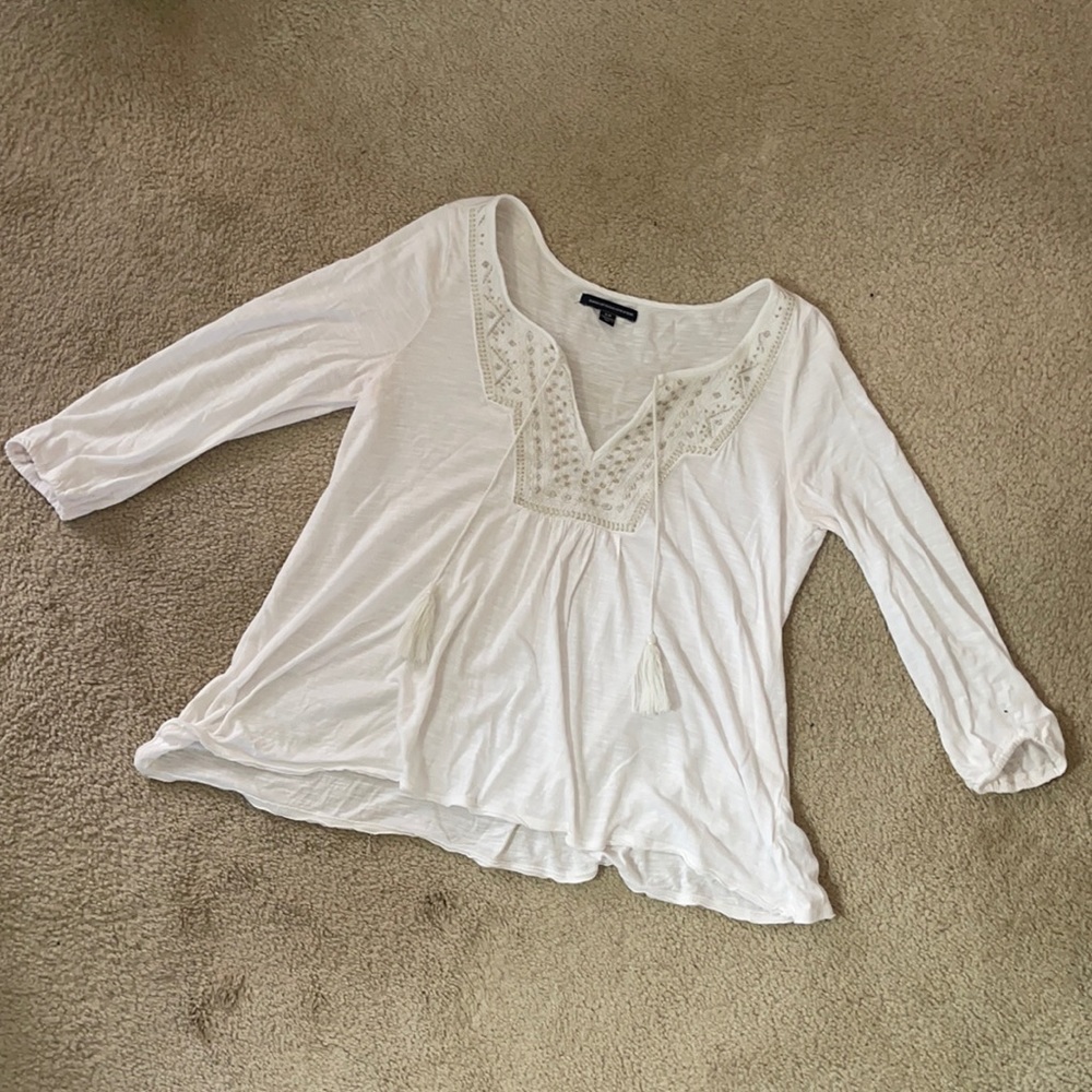 White blouse with tassels